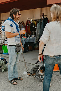 a couple people enjoying St. Jacobs Market Open Air Antique Fair with a dog 