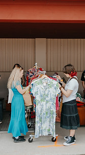 A few people browsing a clothing rack  at St. Jacobs Market Open Air Antique Fair 