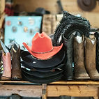 display filled with cowboy boots, hats and other leather goods from Amigos Distributing 
