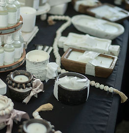 A table display with decorative candles and oils 