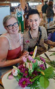 Image of two people at St. Jacobs Market attending the Mother's Day Workshop and making a floral arrangement