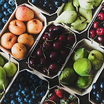 Colourful display of fresh produce including pears, cherries, blueberries, strawberries, and peaches by Produce Express 