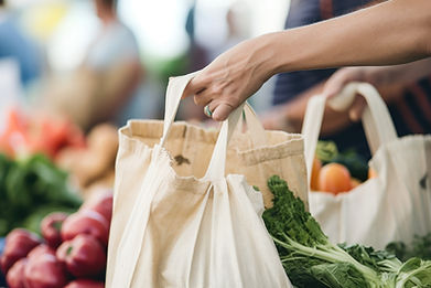 A customer picking up canvas shopping bags filled with produce purchased at St. Jacobs Farmers' Market 