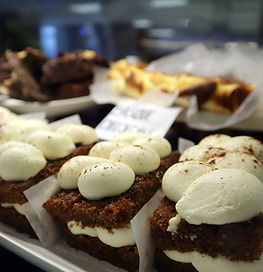 A display case filled with cakes and sweet treats 