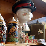 A manequin head displaying a vintage hat and other items by Bygone Reflections