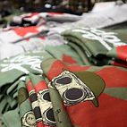 Piles of military inspired t-shirts displayed at D-Day Wear 