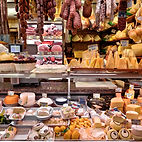 Display cabinet filled with cheeses and meats at Eva’s Deli