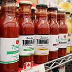 A selection of tomato sauces on a shelf at Eatario