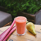 Healthy Smoothie with Rhubarb and a sitting beside the glass from Smooties & Things pear