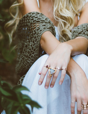 A woman's hands modelling several artisian rings