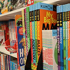 Bookshelves filled with children's books at Kids Den Booth
