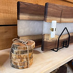 2 wood and resin serving board with a stack of wood coasters from Pasca A Timber Creations 