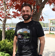 A man modeling the 50th anniversary logo t-shirt 