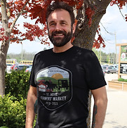 A man wearing the St. Jacobs Farmers Market 50th anniversary Logo T-shirt 