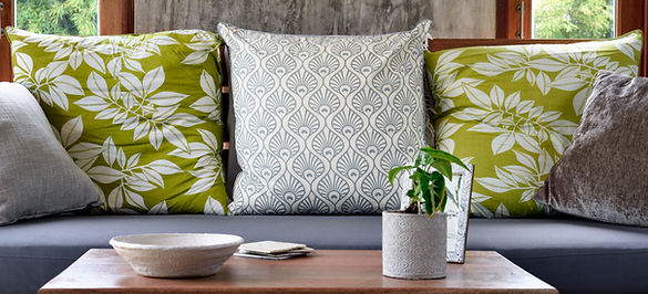Patterned Pillows displayed neatly on a grey couch showcasing some of the wares at St. Jacobs Outlet Mall 