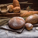 a beautiful display of several fresh breads, fresh grains and oats at Grainharvest Breadhouse 