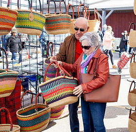 an elderly couple shopping for wicker bags 