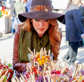 a woman admiring floral bouquets 