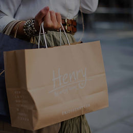 Woman holding a paper shopping bag at St. Jacobs Outlet Mall