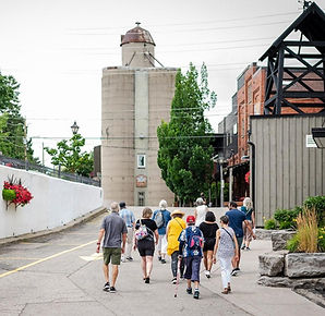 A group strolling through the town of St. Jacobs on a walking tour 
