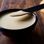 Tahini Sauce in a bowl on a wood board from Organic Chef Foods 